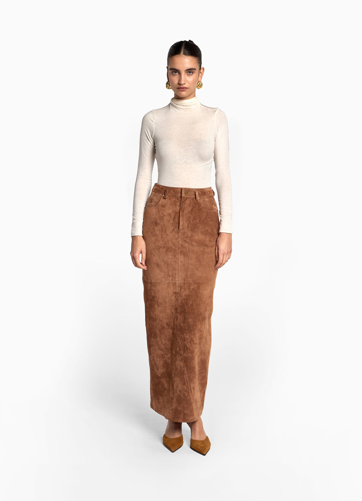Front view of model wearing mocha suede skirt in maxi length with pencil skirt fit.
