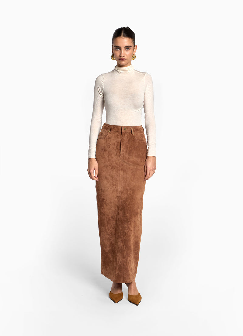 Front view of model wearing mocha suede skirt in maxi length with pencil skirt fit.